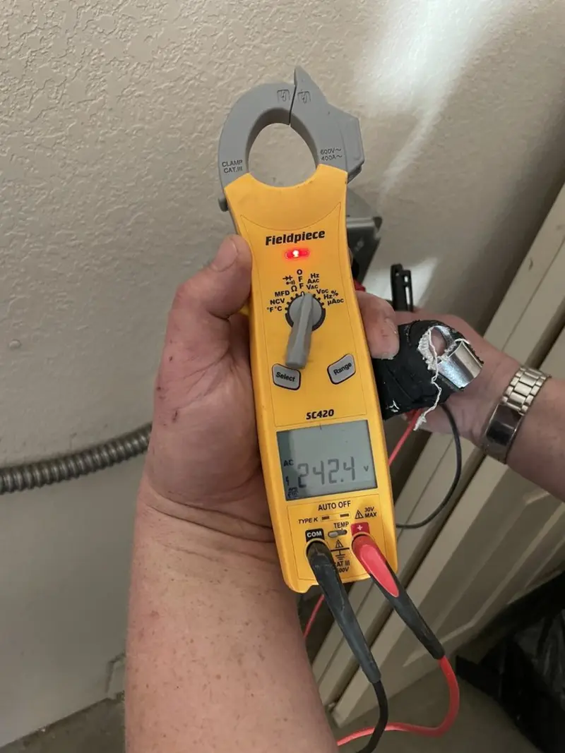 Voltage testing with clamp meter during Electrical Installation Services in Norton Shores
